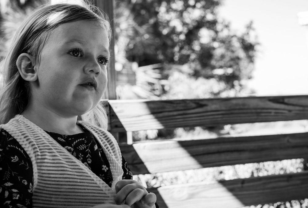 Black and white portrait of a young child looking off into the distance.