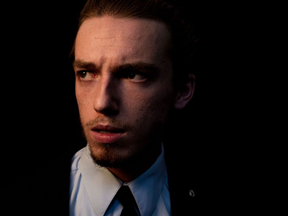 Atmospheric portrait with minimal lighting emphasizing facial contours.