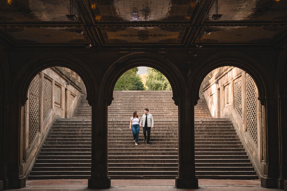 View through stone archways of historic steps with figures in the distance.