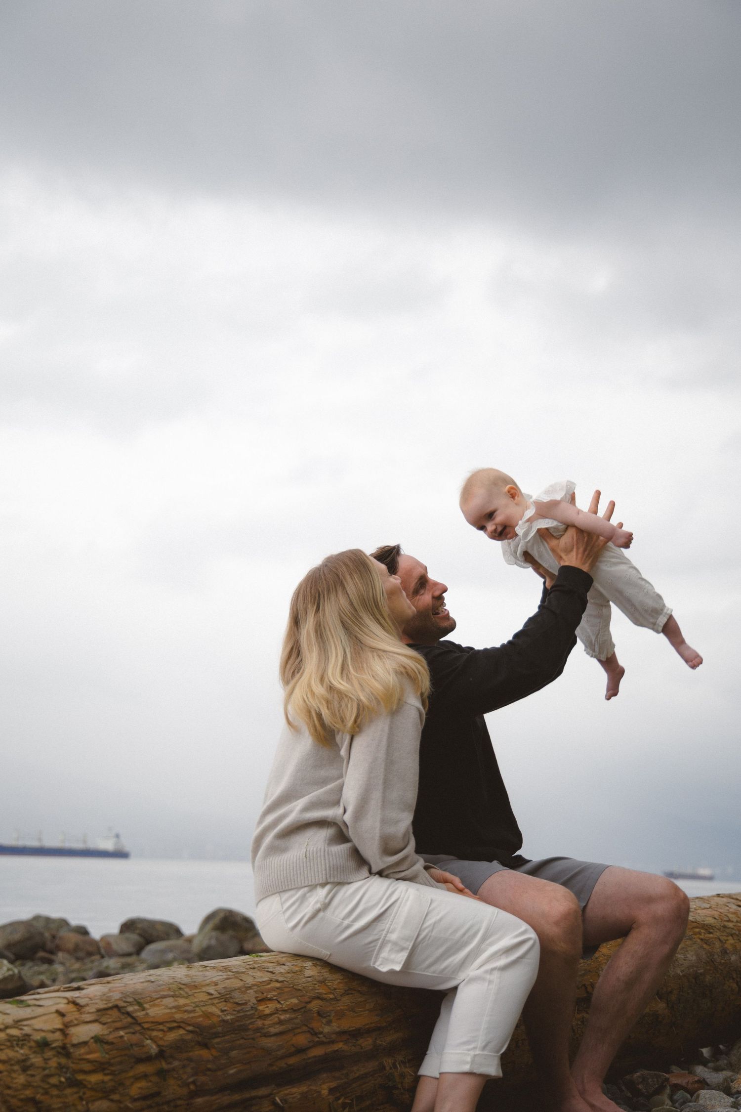 rainy vancouver beach photo session with young family and their six months old baby