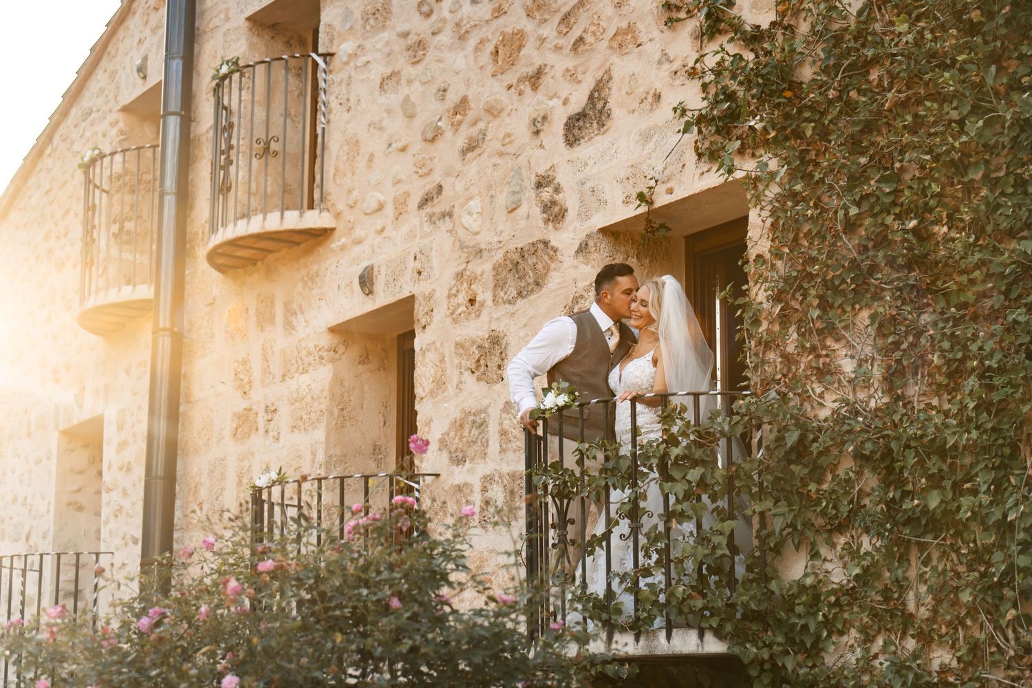 Couple getting married in Penáguila Valencia Spain countryside. Couple kissing and embracing at their boda,  country house with golden sun