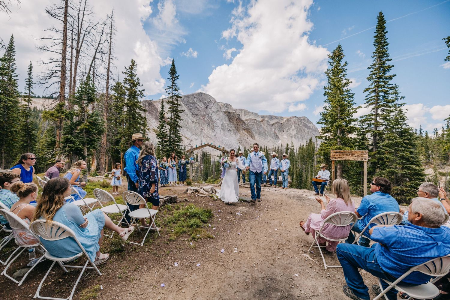 Moody bride and groom in a bright beautiful grass  after their wedding ceremony in Utah.