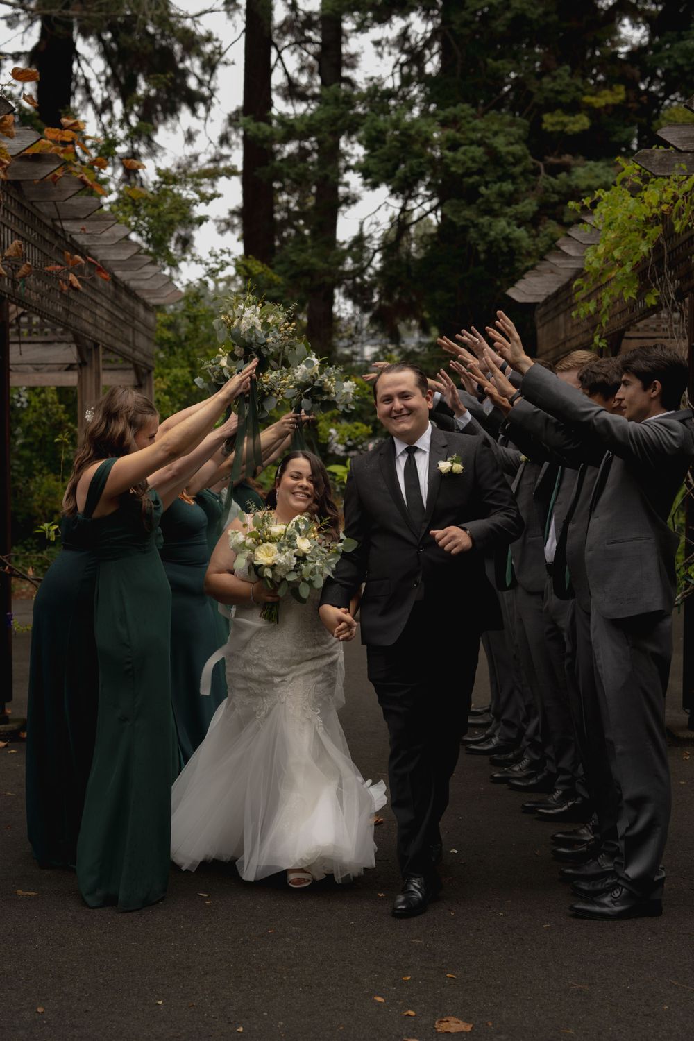 Wedding party creates a celebratory tunnel for the newlyweds to walk through.
