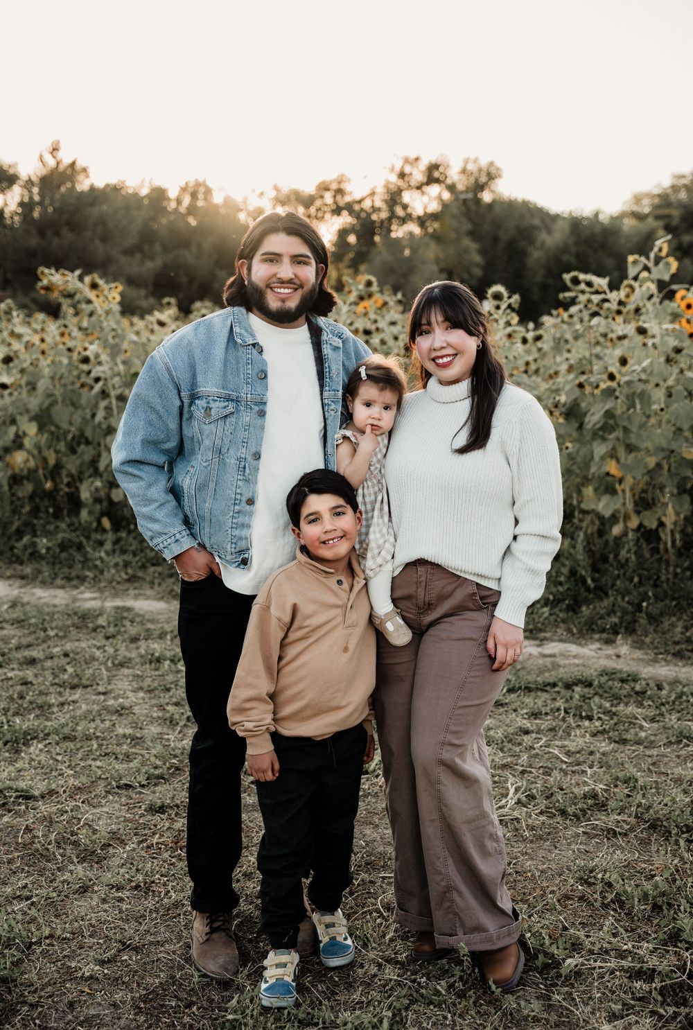 Natural family photographs showing playful moments among sunflowers.