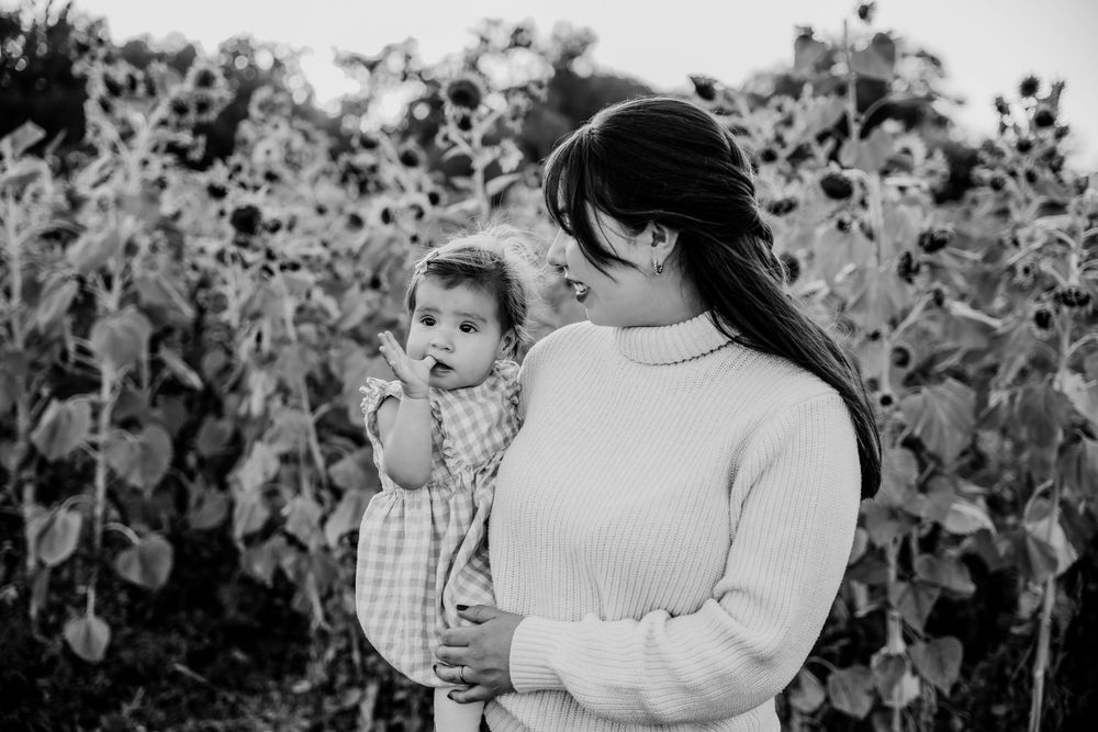 Black and white candid family photos showing tender interactions.