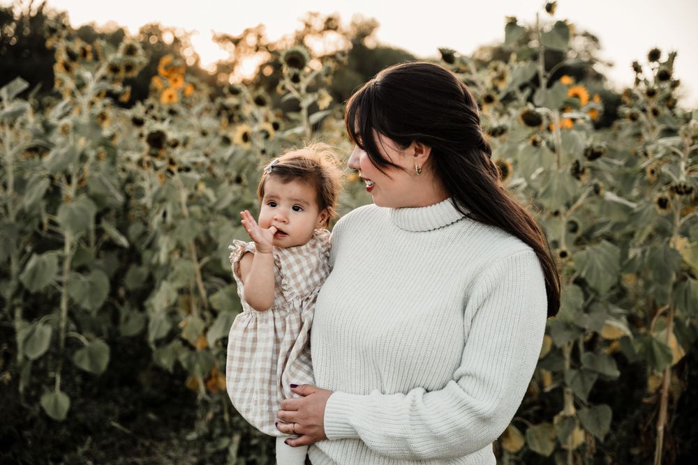 Candid family moments photographed against a backdrop of sunflower fields.