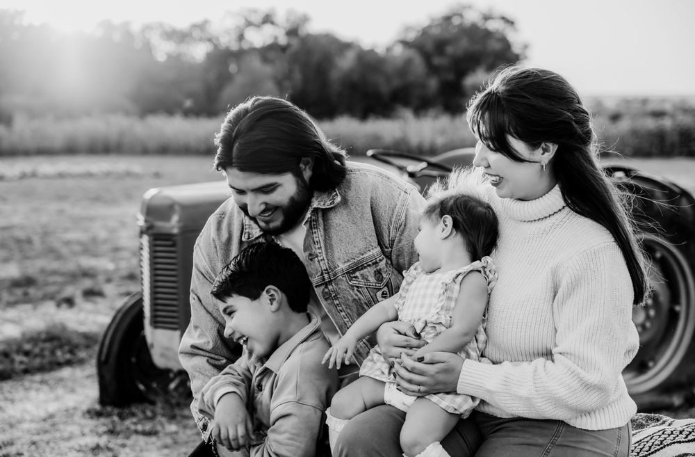Black and white lifestyle photos capturing tender family moments outdoors.