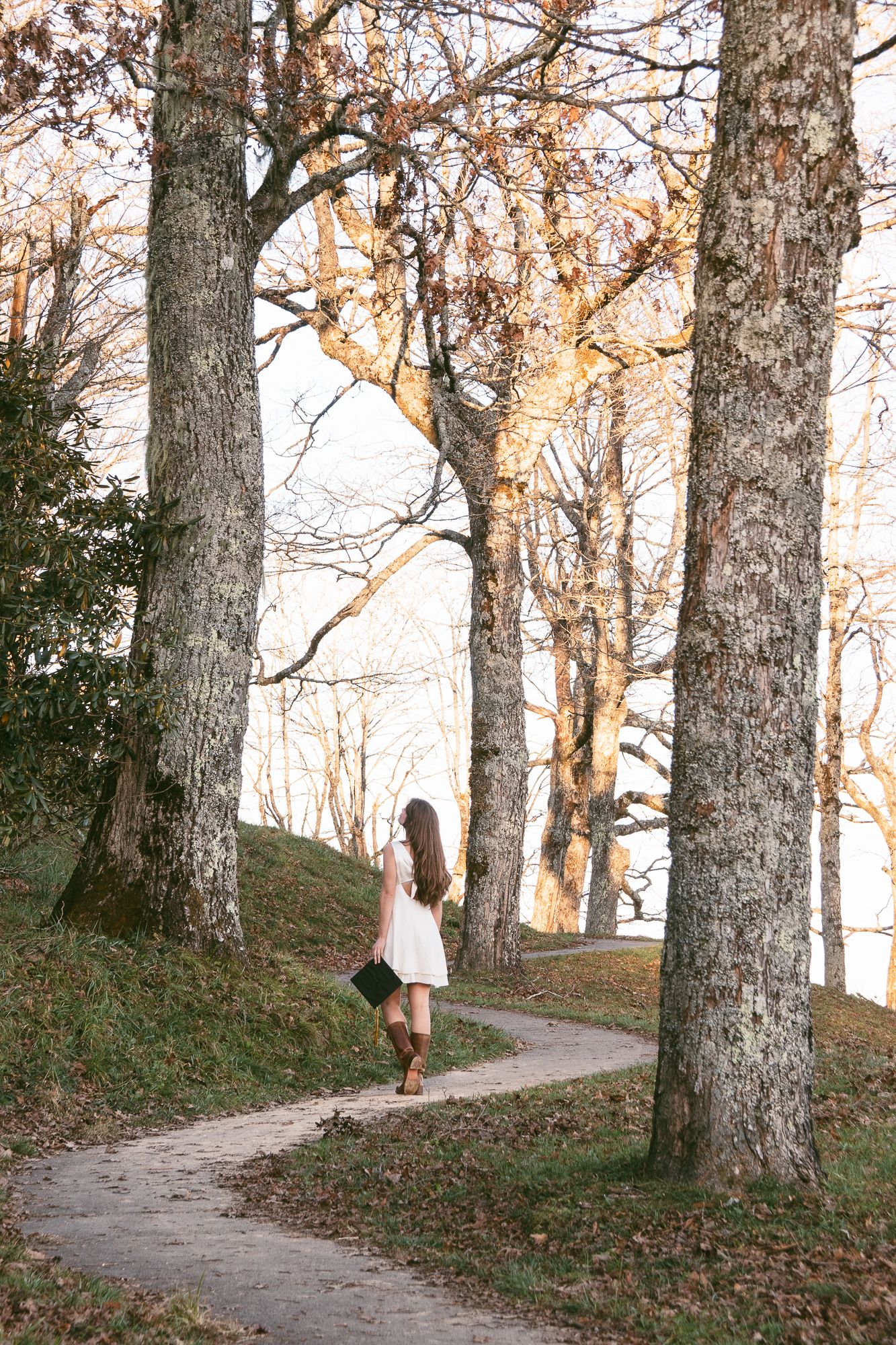 Sequence of someone walking along a winding forest path during autumn. Luxury wedding photographer North Carolina