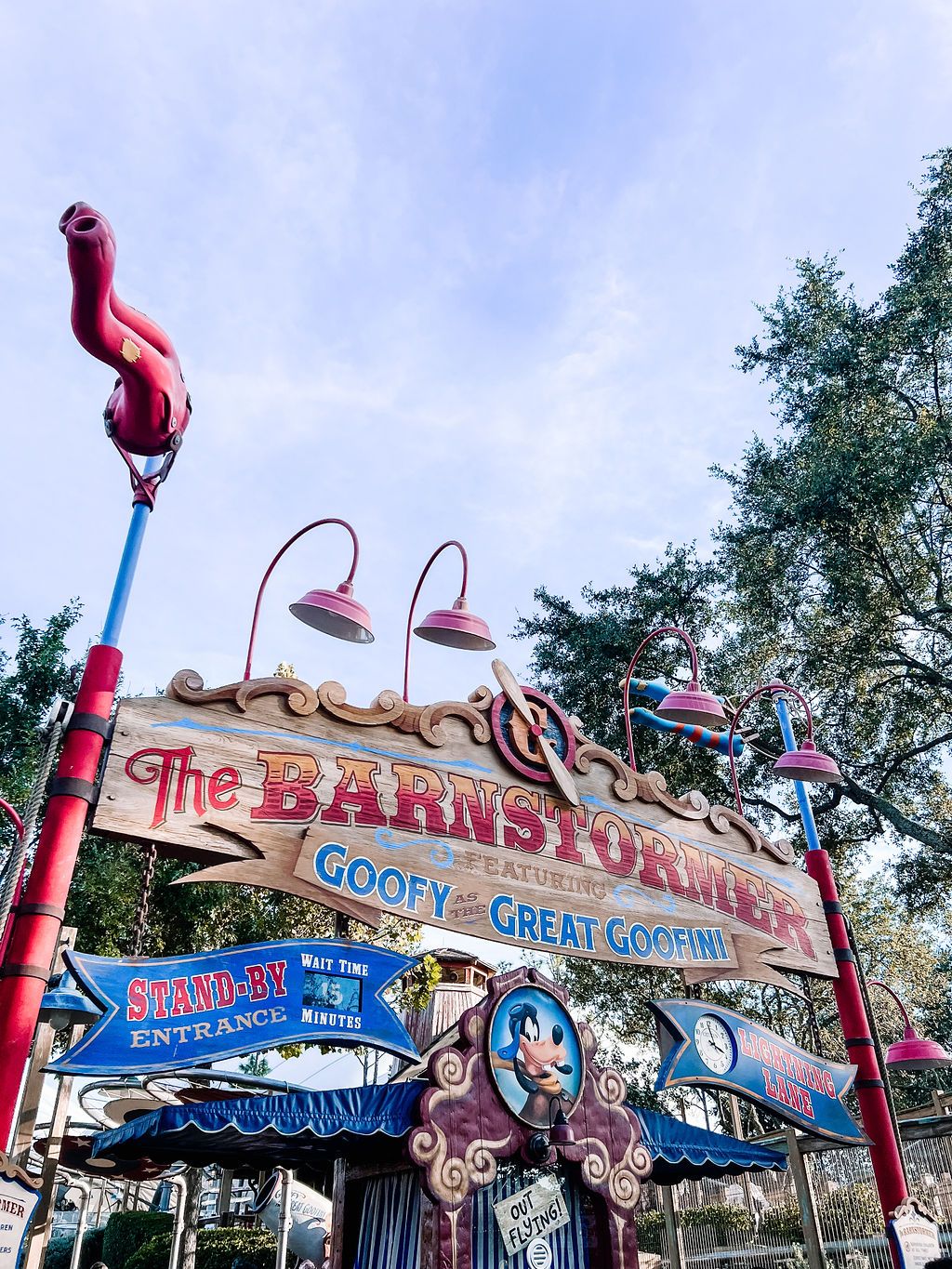 Colorful entrance sign for The Barnstormer roller coaster ride at Magic Kingdom with whimsical circus-themed design.