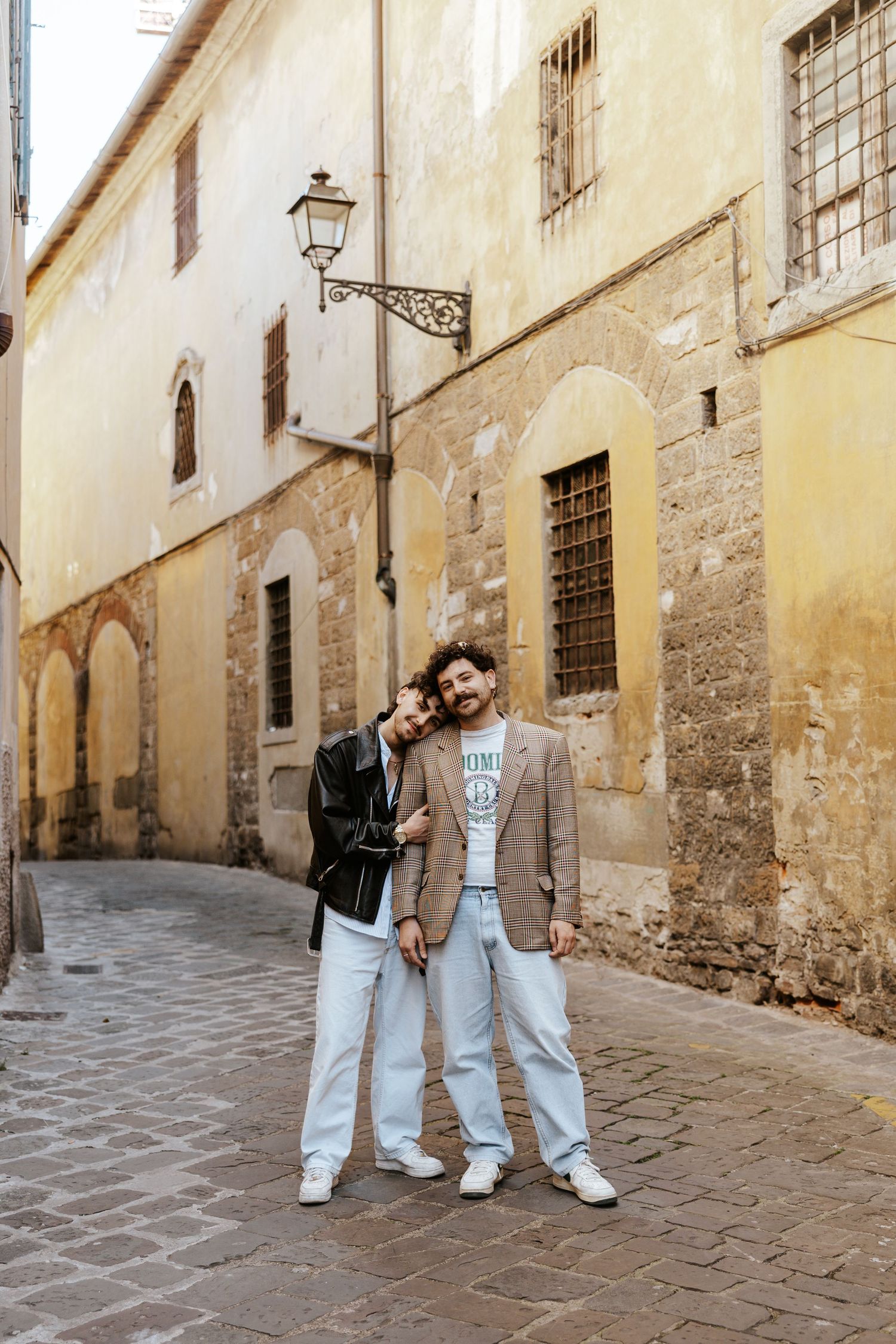 lgbtq+ couple snuggling up in an alley in Florence, Italy