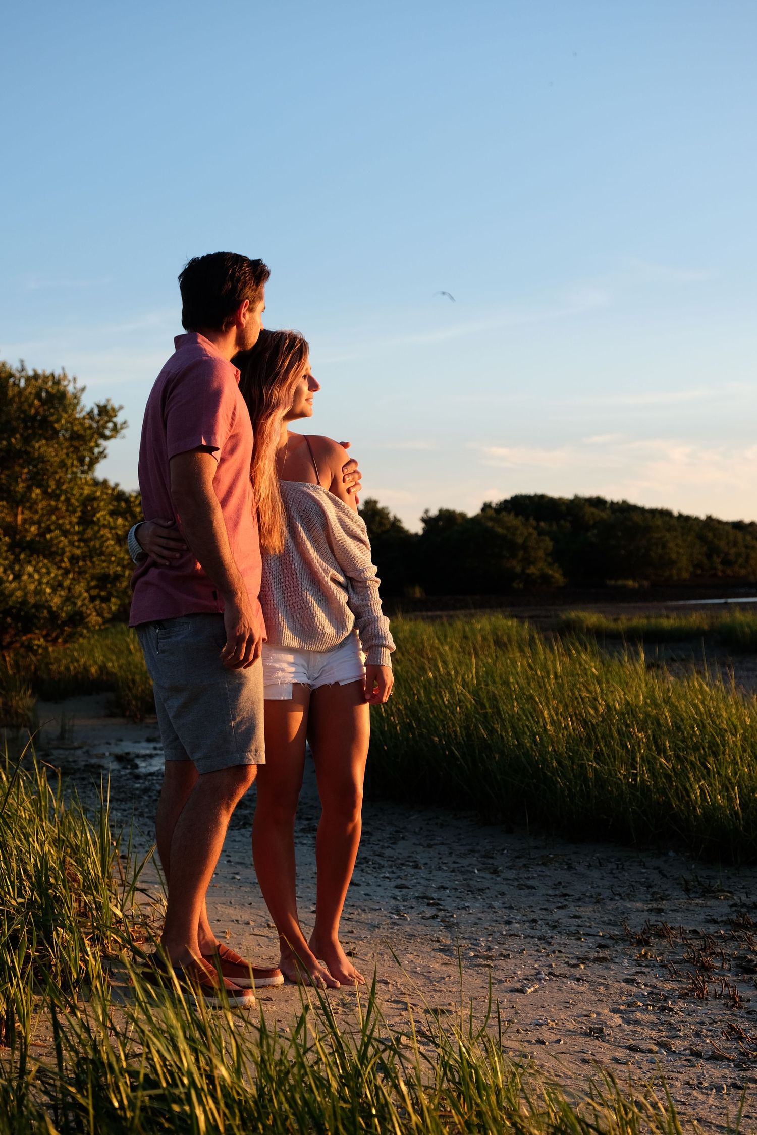 Couple embraces at sunset on a Florida beach.