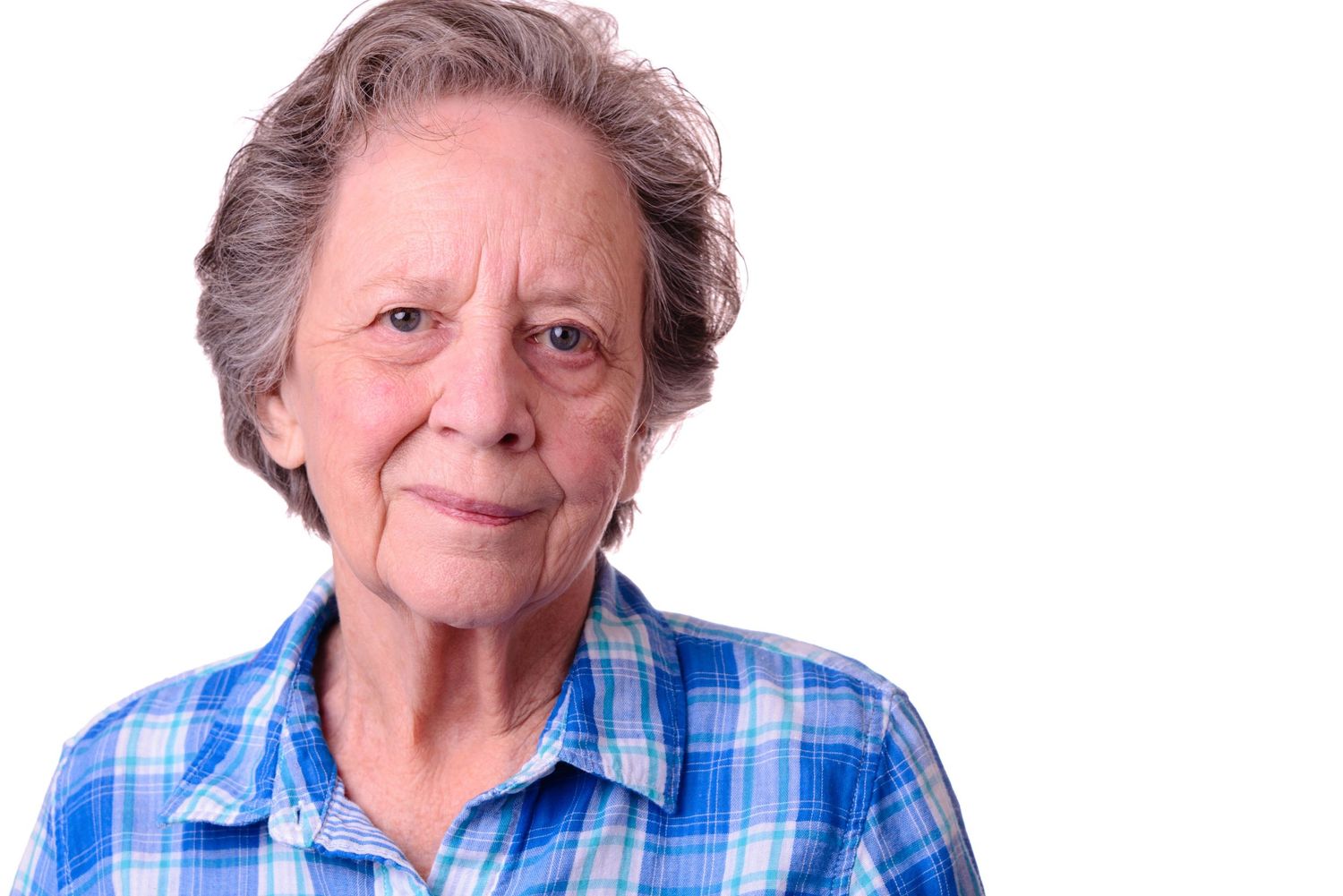 A woman poses for a commercial headshot against a white background. - photo by Chris Watkins Photography