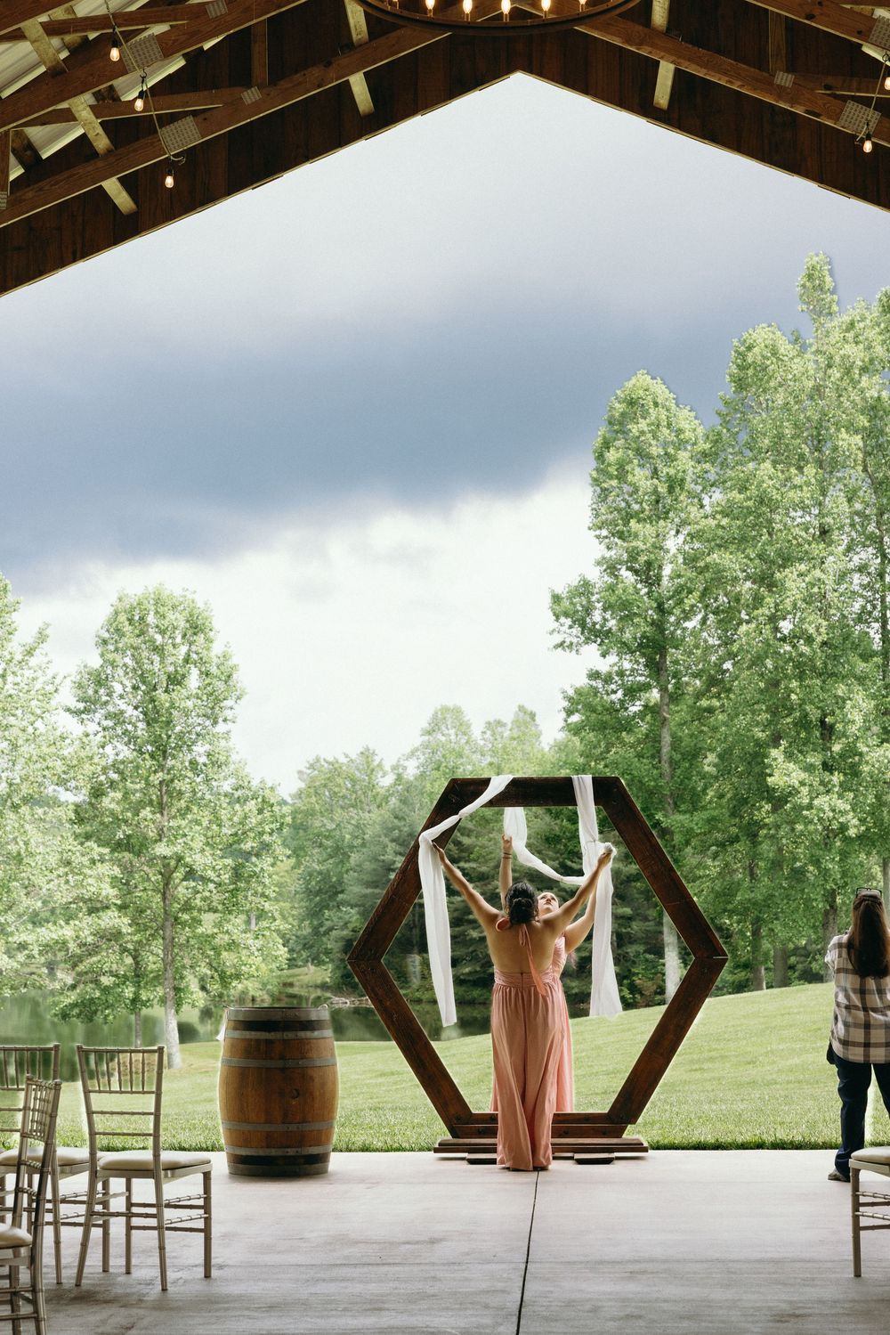 Outdoor wedding ceremony setup with hexagonal arch and rustic barrel decor. Estate and historic venue wedding photographer for NC