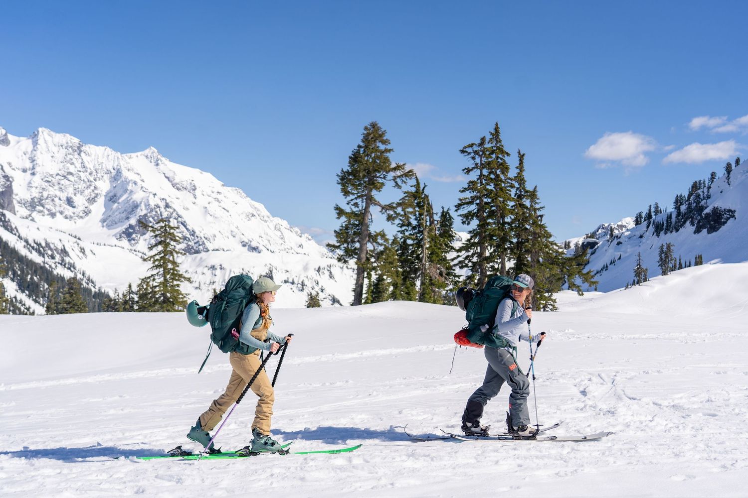 Two backcountry skiers skinning