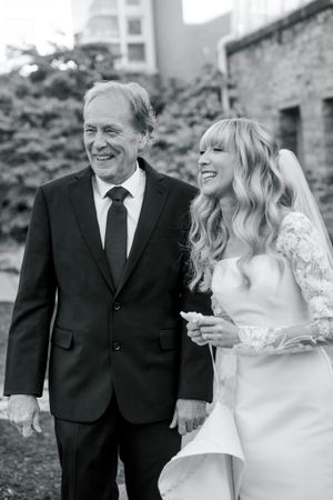 Black and white candid moment shared between two people on wedding day.