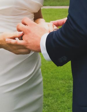 Close-up sequence of hands performing a traditional handshake gesture against a green outdoor background.