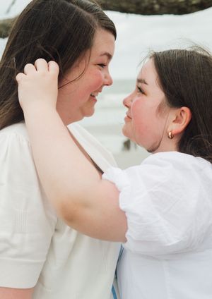 A series of intimate photos showing a tender emotional moment between two people in white clothing.