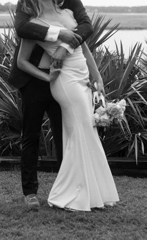 A black and white photo series showing the lower half of a couple dancing, with the bride in a white dress against foliage.