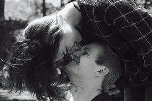 A romantic black and white photo series showing a couple embracing in an intimate moment.