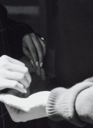 Black and white close-up series of hands reaching and intertwining.