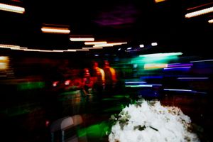 Colorful nightclub scene with neon lights and atmospheric fog effects.