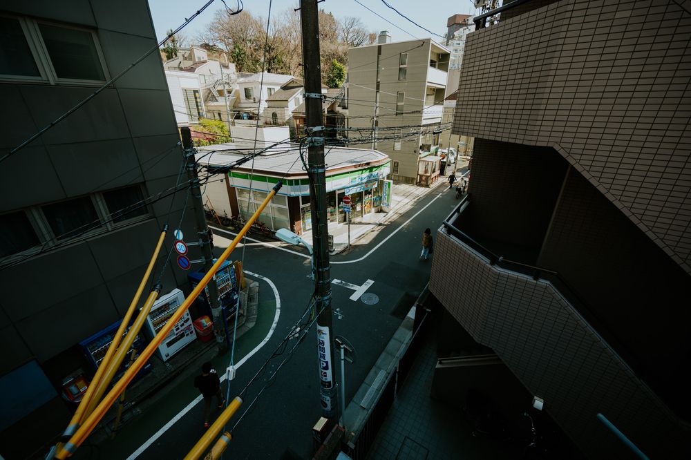 A collection of photos showing a cluttered Japanese apartment interior with wires, storage, and everyday items.