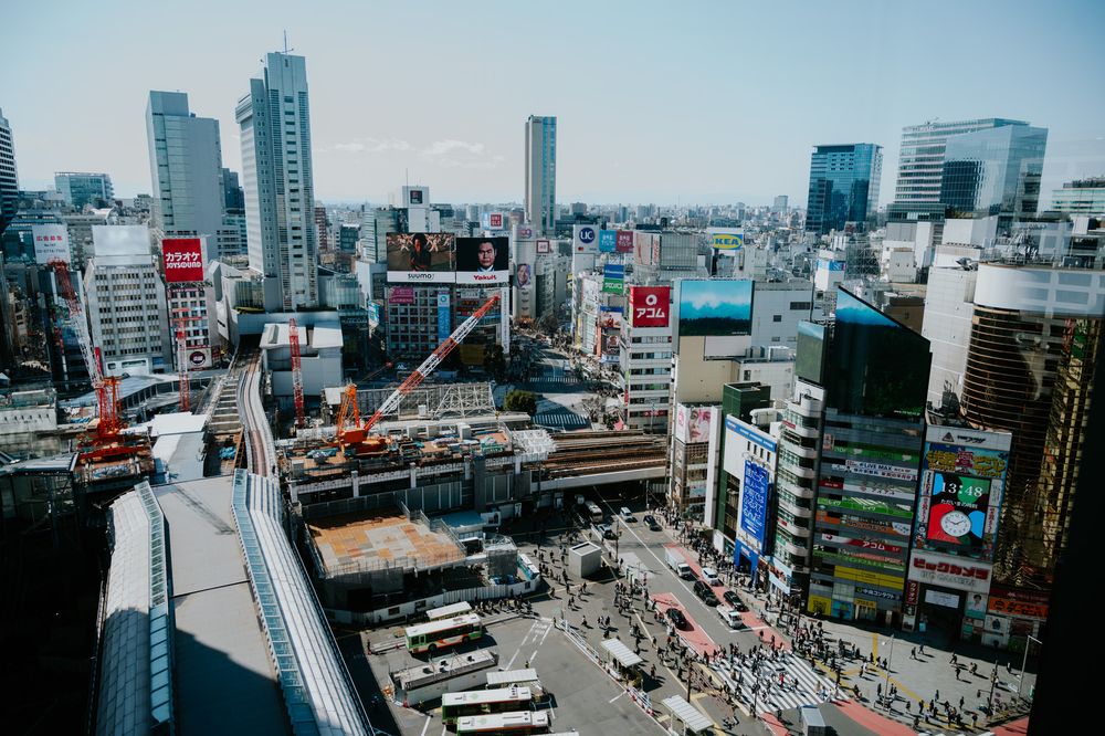 Modern cityscape showing aerial panoramic view of buildings and roads during daytime in downtown Tokyo, Japan.