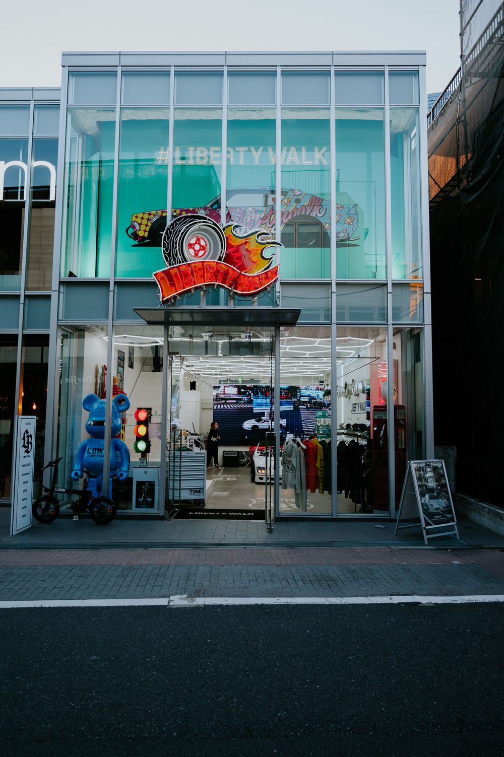 Liberty Walk shopping storefront with illuminated signs and glass windows in an urban setting.