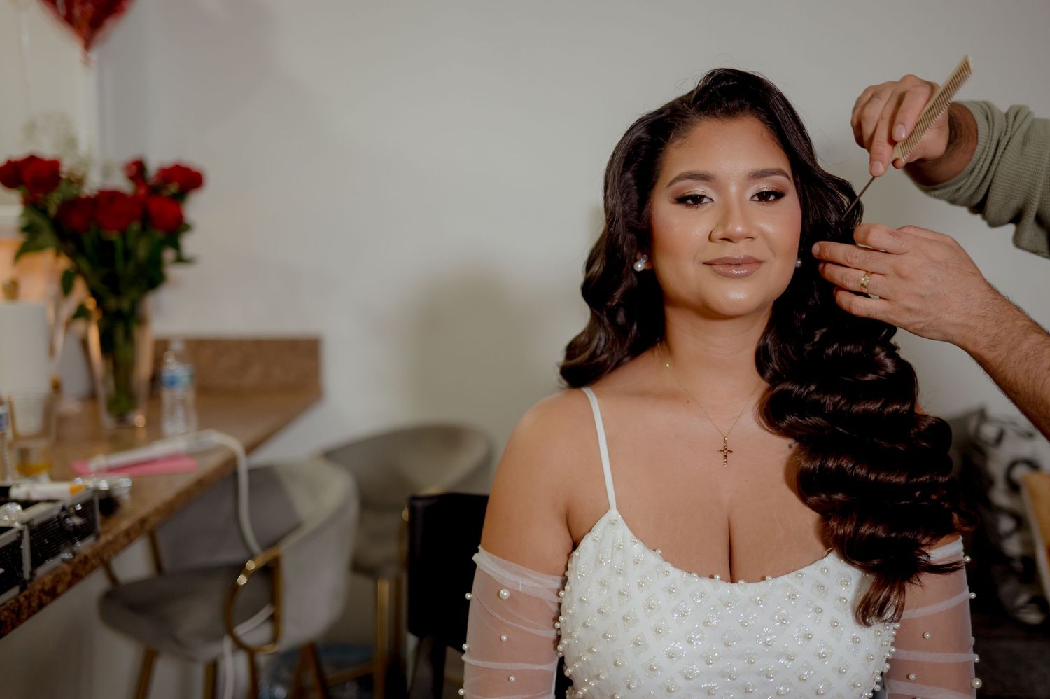 A sequence of moments showing a bride getting ready with hair styling and finishing touches on her wedding day.