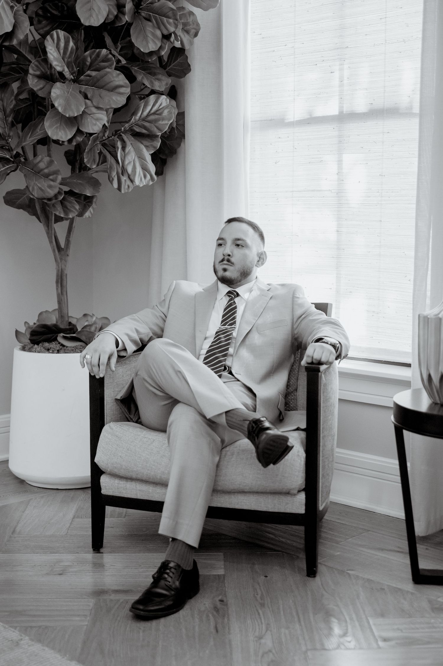Series of lounging photos on a white bench with floral decor and hardwood floors in the background.