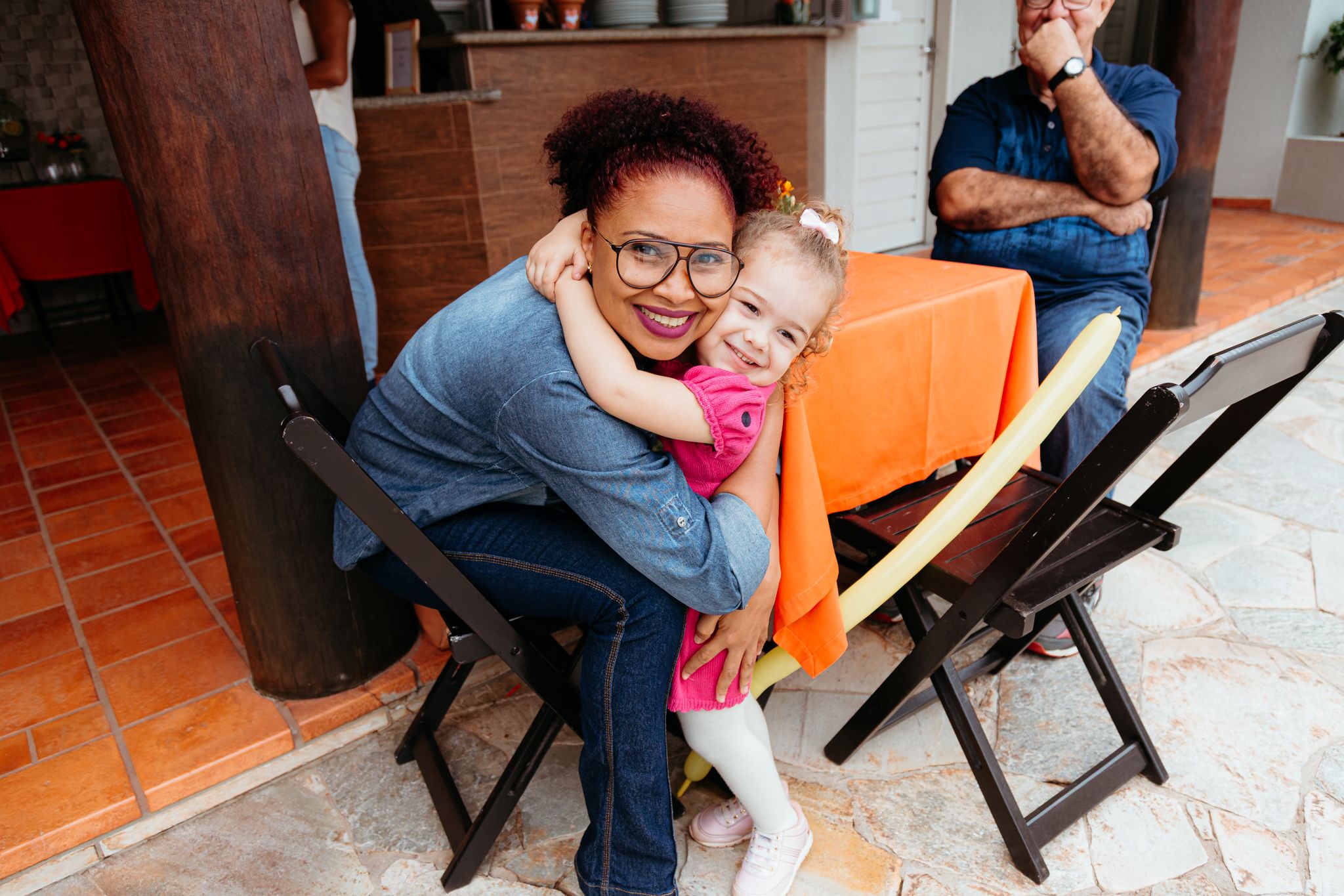 Two people sit together in loving embrace on a wooden bench outdoors in a series of tender moments.