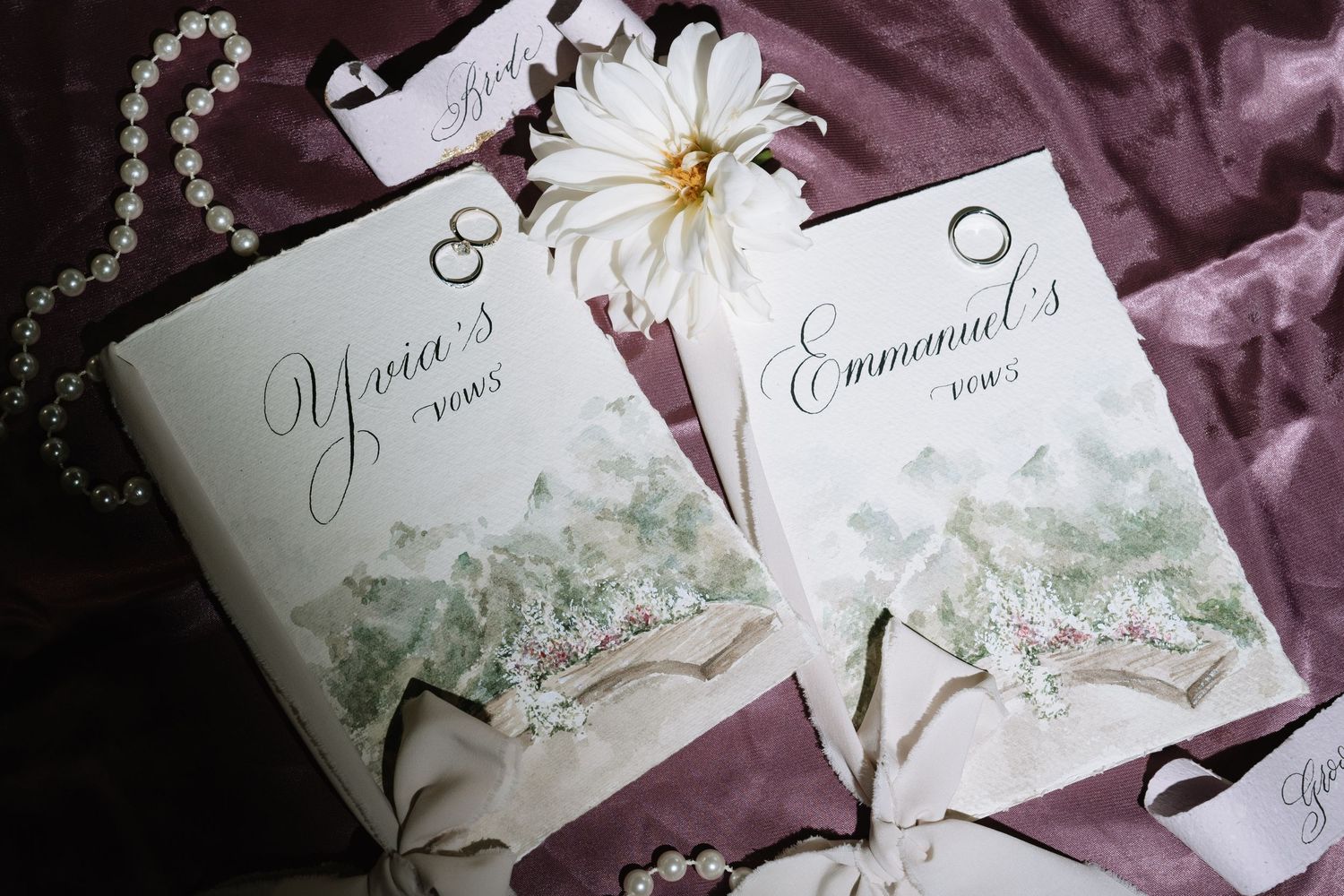 Custom wedding vow books for Yvia and Emmanuel decorated with watercolor florals and white dahlia.