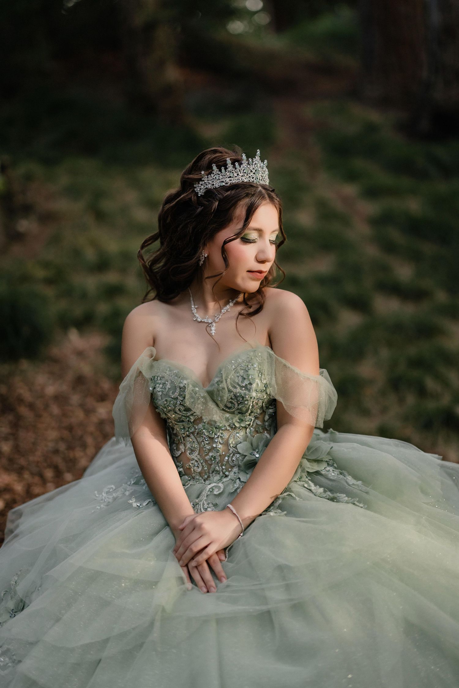 Mint green princess gown with intricate beading and sweetheart neckline captured in enchanted forest setting.