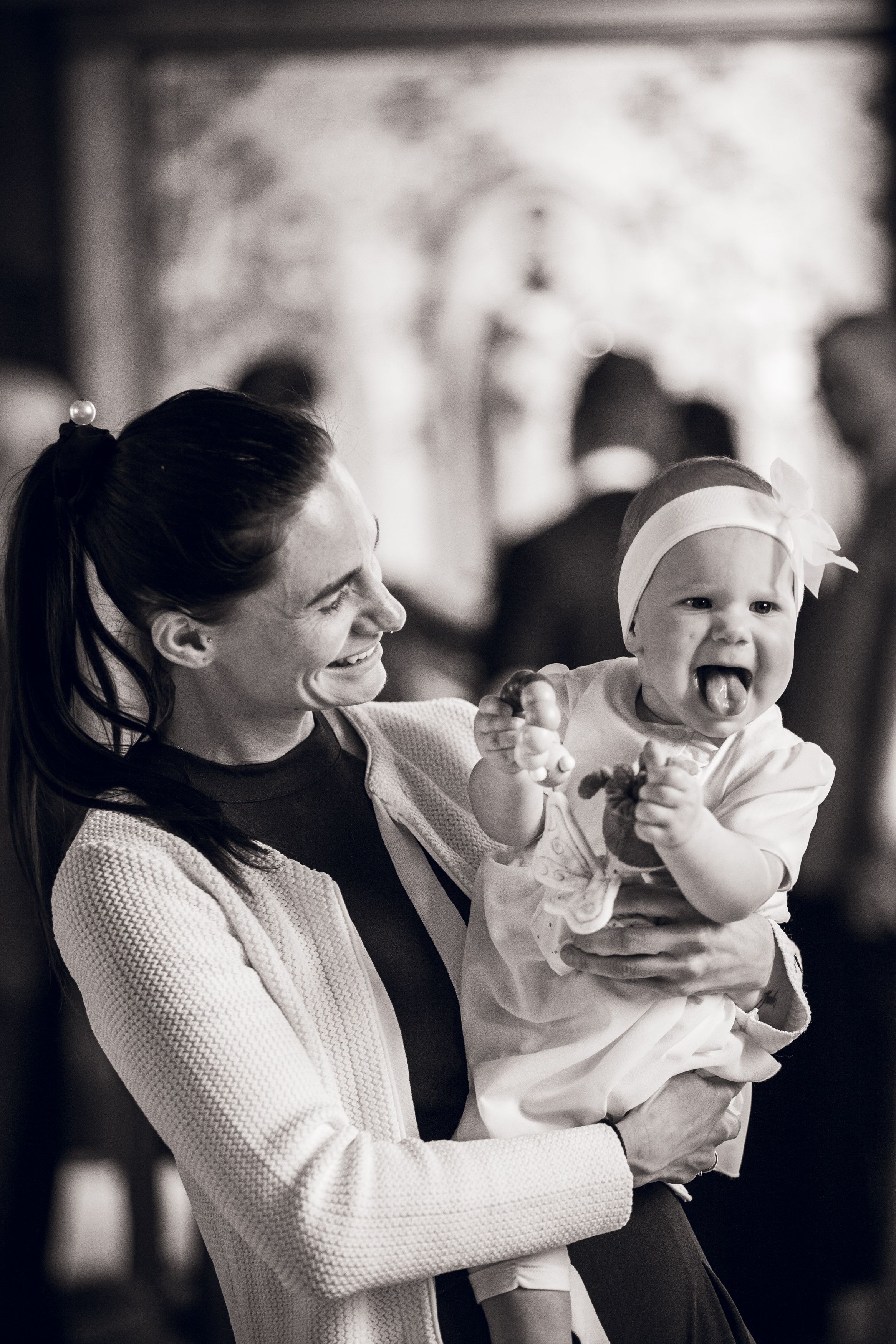 Black and white series of photos showing tender moments between parent and small baby in casual domestic setting.