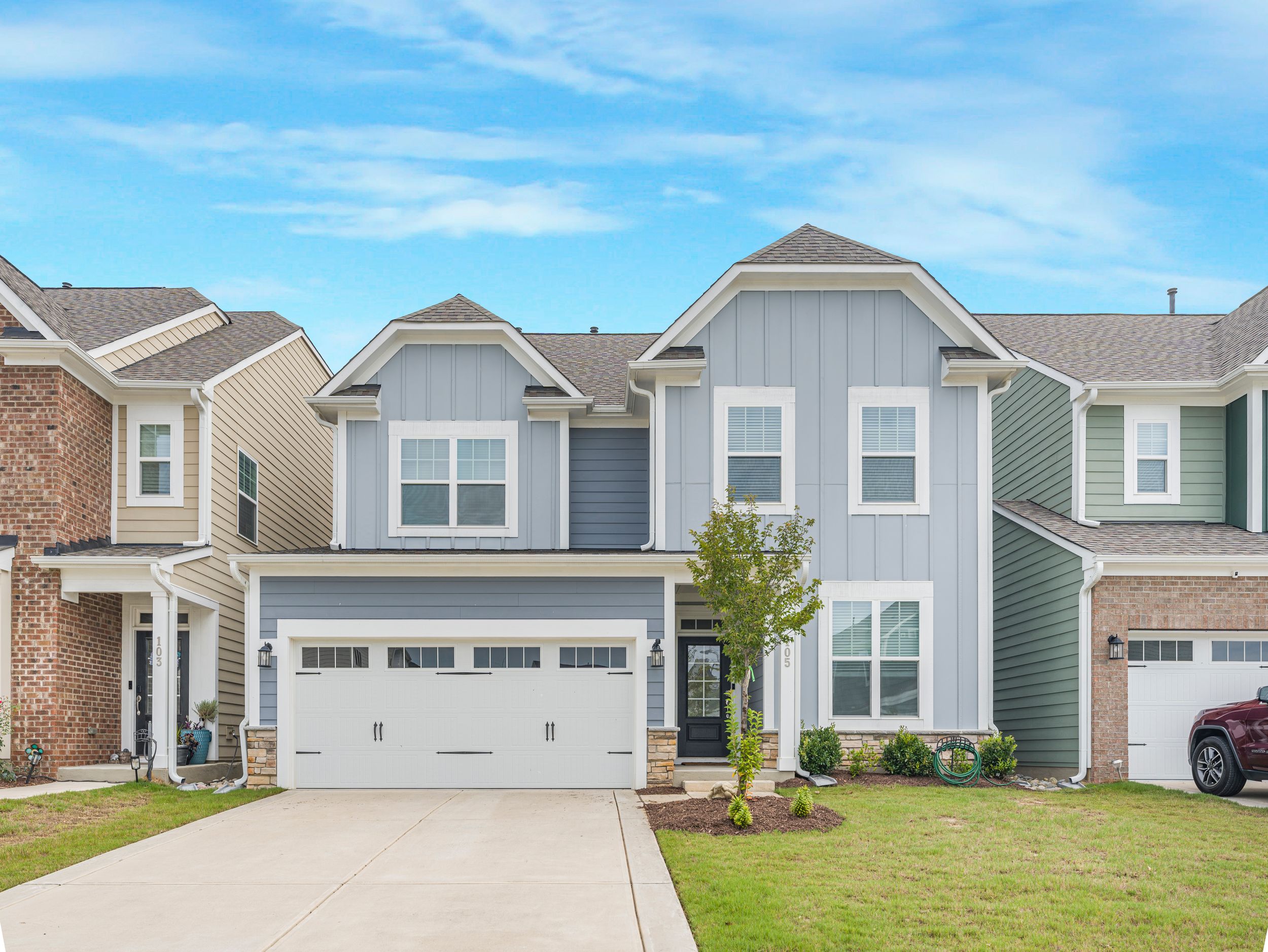 Aerial view of suburban neighborhood with new construction homes and well-maintained lawns.