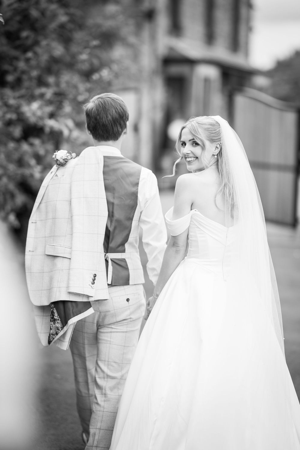A black and white photo sequence showing a bride and groom walking away together in formal wedding attire.