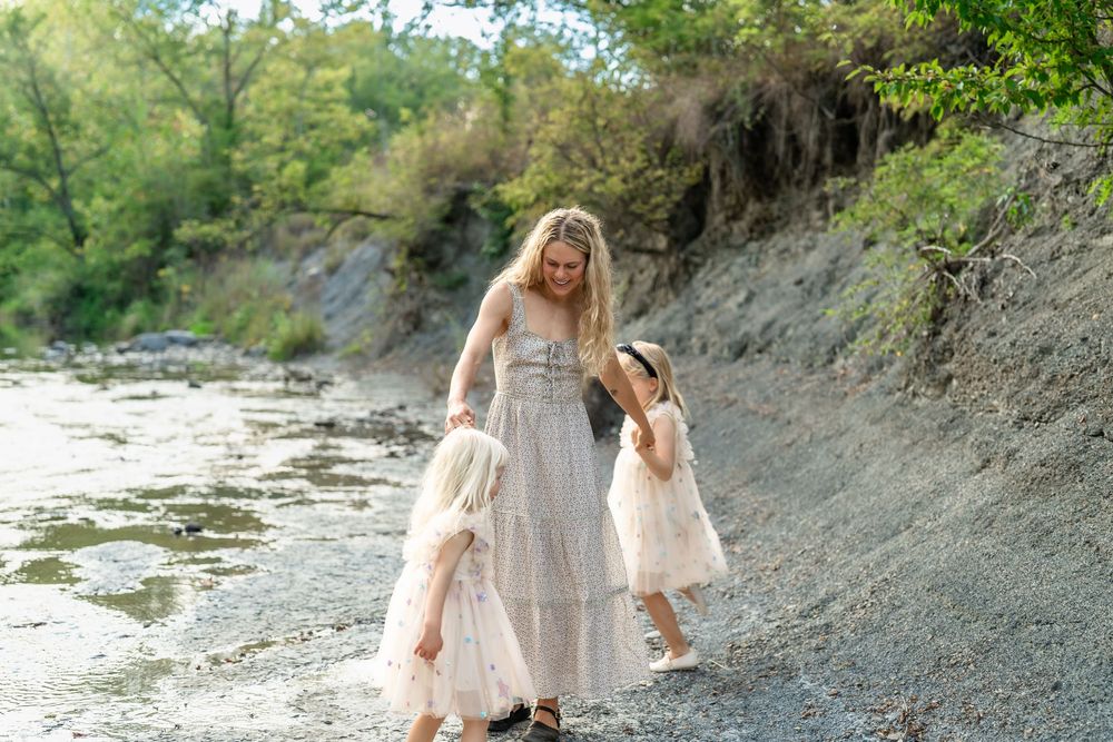 A romantic photoshoot takes place on a rocky riverbank with natural scenery in Cleveland, Ohio for a Family Photo Session