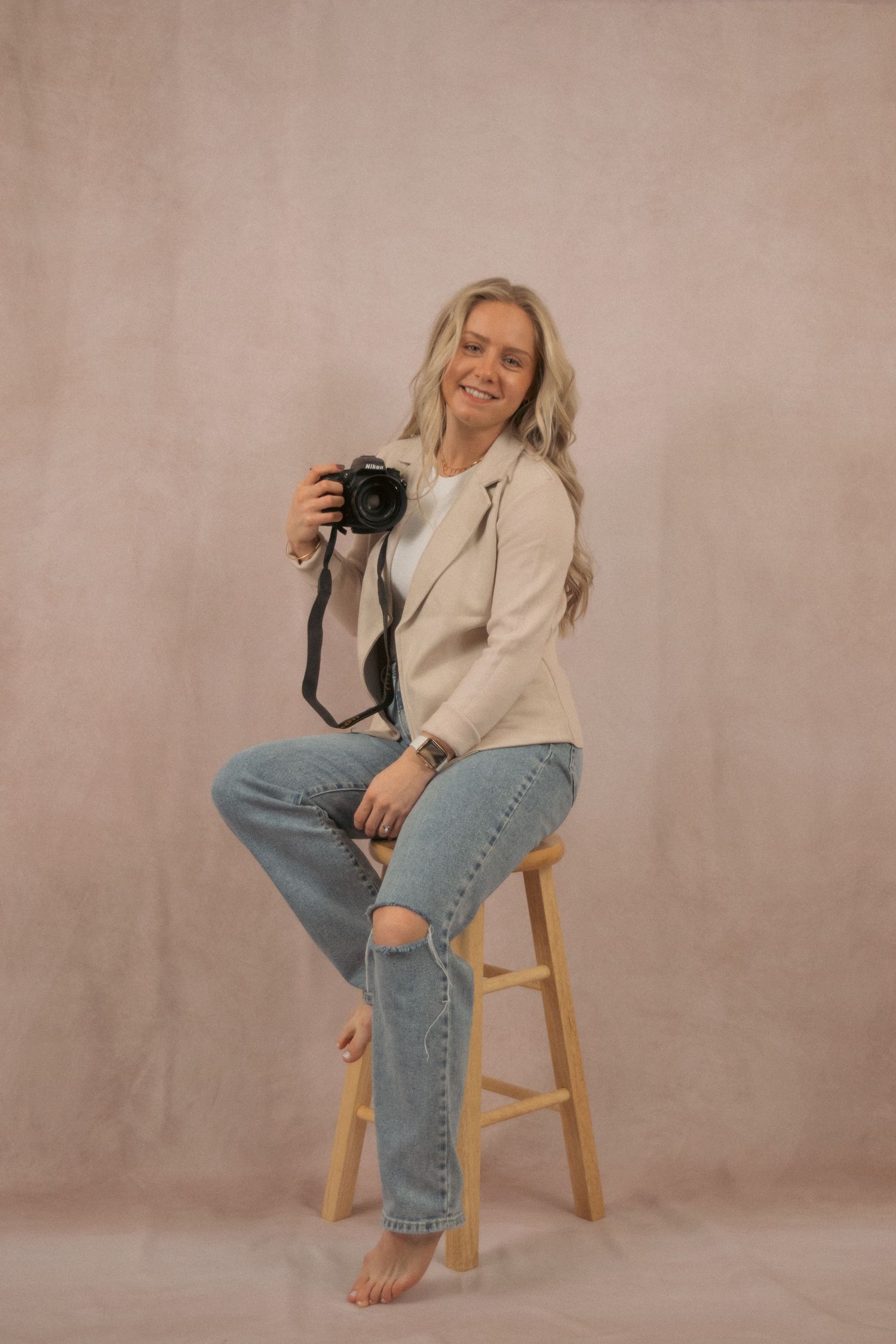 Studio portraits showing casual poses on a wooden stool against neutral backdrop.