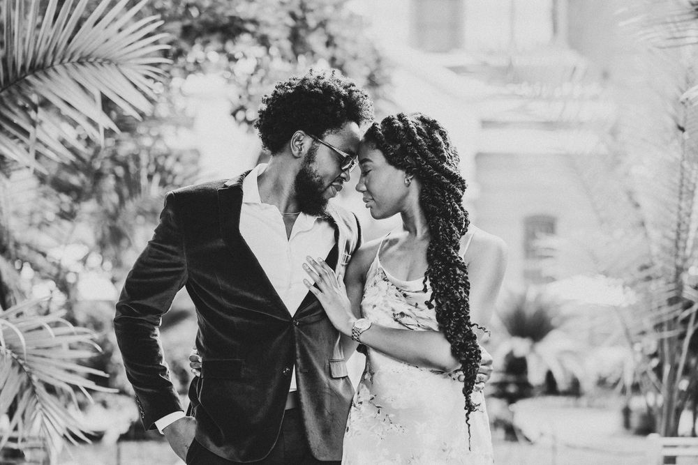 Black and white couple photos showing romantic moments in the Enid A. Gardens