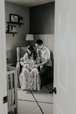 A series of three black and white photographs showing tender family moments on a couch in a home interior.