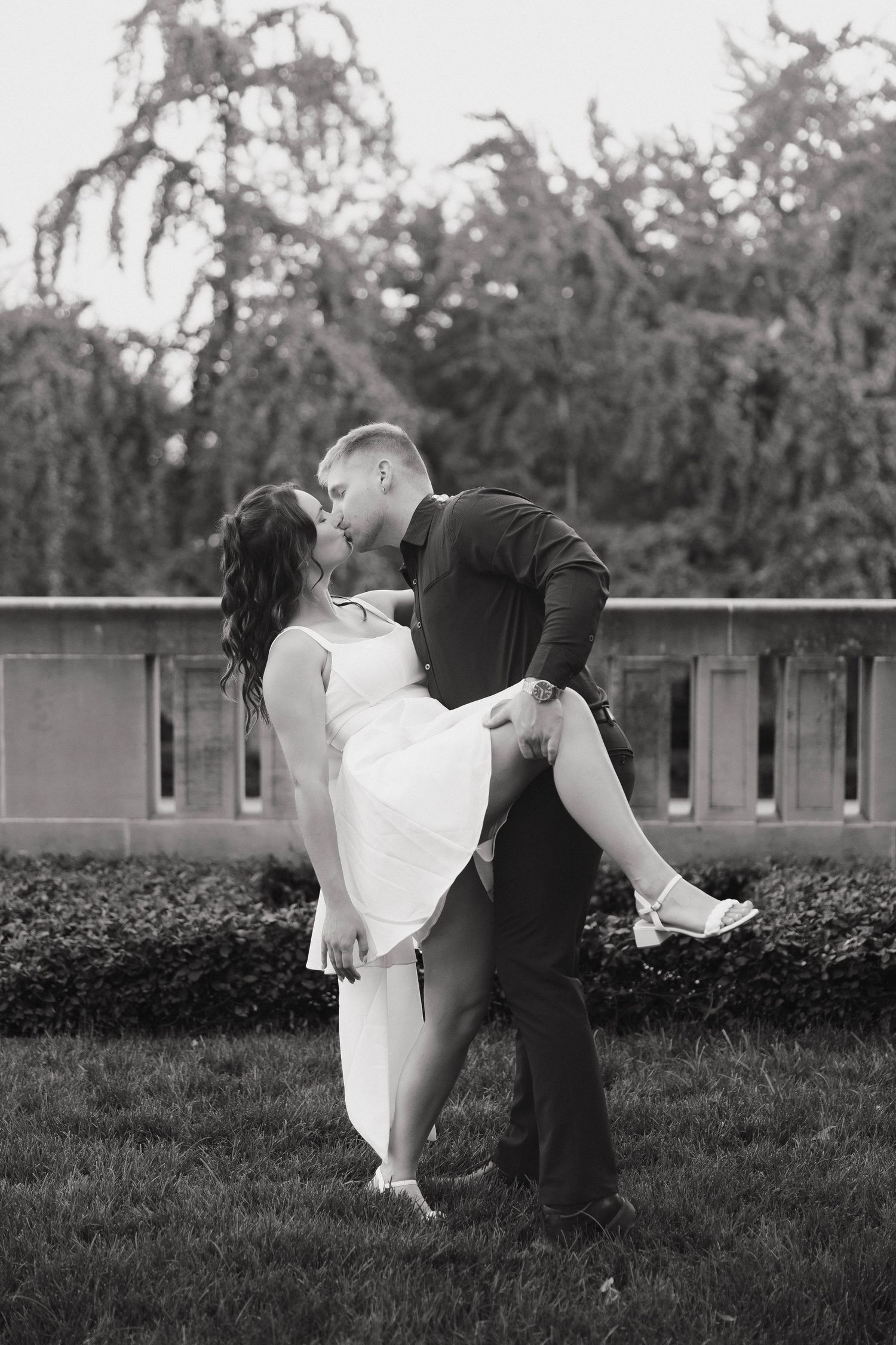 A romantic black and white wedding photo sequence shows a couple dancing with a dramatic dip on a grassy lawn.