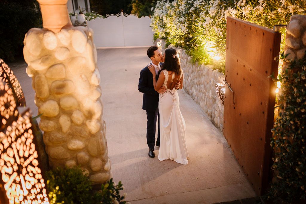 Romantic evening reception scene with decorative lighting and floral arrangements.