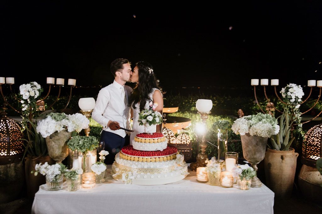 Nighttime wedding reception decorated with lanterns and ambient lighting creating romantic atmosphere.
