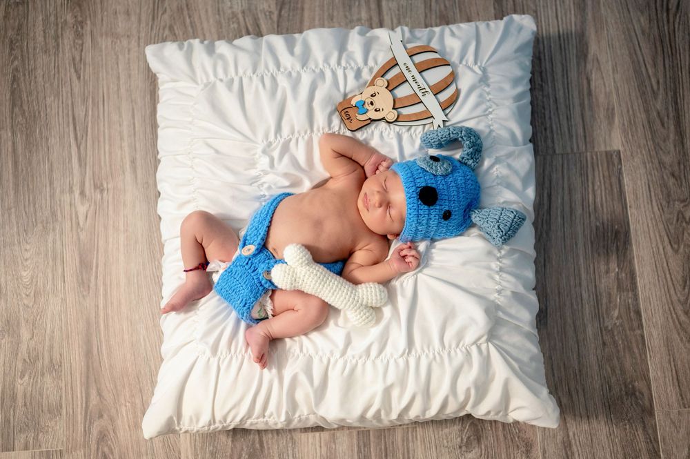 A progression of images showing a small blue plush toy being placed on a white pillow against a wooden floor.