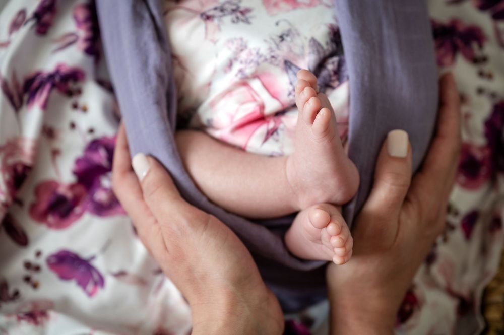 A series of connected photos showing hands applying face cream in a skincare routine against a floral background.
