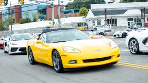 Collection of luxury sports cars including Corvettes and exotic vehicles on display.