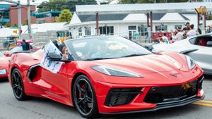 Red Ferrari sports car on display at an outdoor event.