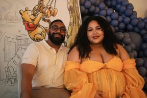 Group photo with yellow and white outfits against blue balloon backdrop.