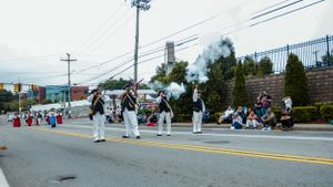 Wide shot of a parade route with crowd barriers and utility poles.