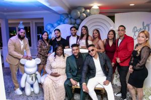A festive indoor party scene with blue lighting and multiple guests mingling.